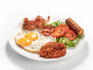 Full English breakfast with fried eggs, bacon, sausage, beans and vegetables