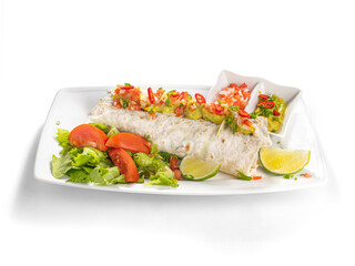 Mexican burrito with vegetables, guacamole and lime on plate