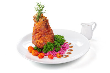 Crispy roasted pork knuckle with herbs, cabbage, tomatoes and sauce on white plate isolated on white background
