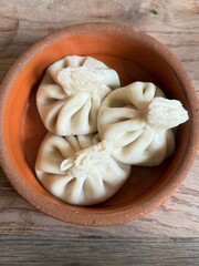 Khinkali dumplings traditional Georgian food on the plate. Handmade boiled dough filled with meat, perfect for cuisine, food, and restaurant concepts. Top view of tasty meal, no people