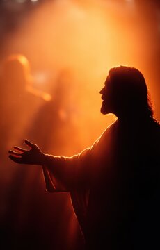 Silhouette of Jesus extending his hand.