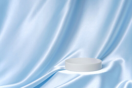 Blue silk background with single round podium