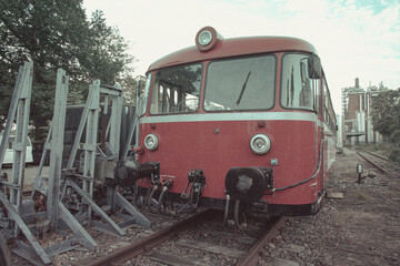 Front view of classic red railbus parked on railway tracks