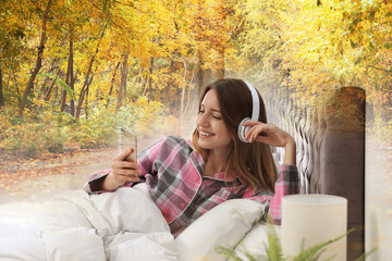 Happy woman listening to sounds of nature which making her feel calm. Double exposure of bedroom and autumn landscape