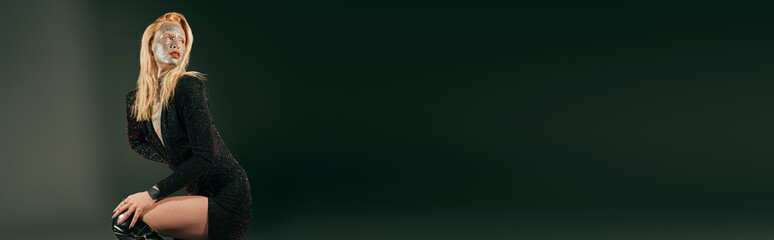 Stunning young woman with glittery face showcasing beauty in a stylish studio setting