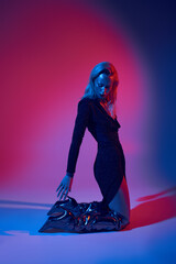 Radiant young woman showcasing glam with glitter in a vibrant studio setting