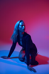 Blonde woman poses with sparkling glitter in glamorous studio setting