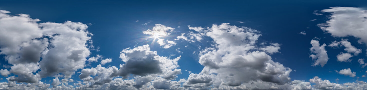 Seamless hdri panorama 360 degrees angle view blue sky with beautiful fluffy cumulus clouds with zenith for use in 3d graphics or game development as sky dome or edit drone shot