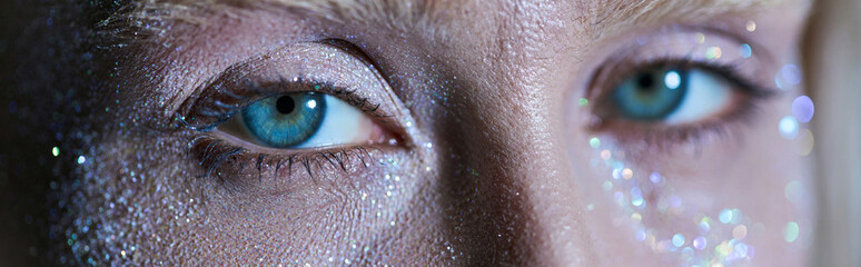 Young woman shines with glitter in a captivating studio beauty session