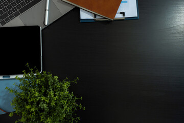 Office equipment with pens, notes, notebooks, tablets, smartphones, mice and coffee mugs placed at the desk.