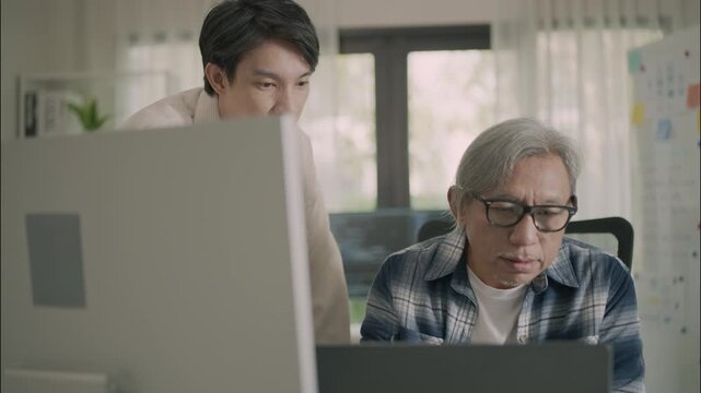 Asian senior student learning programming and robotics with a young teacher, showcasing teamwork, innovation, and digital skills in a modern STEM classroom having a whiteboard in background in the mod