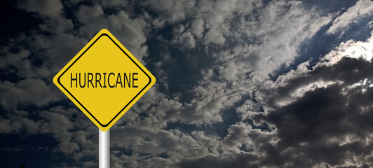 danger,caution,Hurricane Idalia warning sign against a powerful stormy background with copy space. Dirty and angled sign with cyclonic winds add to the drama.hurricane season sign on cloudy background