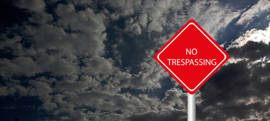 No trespassing attention sign on background 