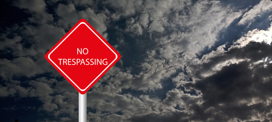 No trespassing attention sign on background 