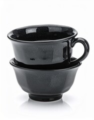 Glossy Black Ceramic Cup Stacked Atop Bowl Still Life on White Surface in Studio