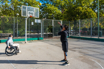 Athletes playing adaptive basketball on outdoor court