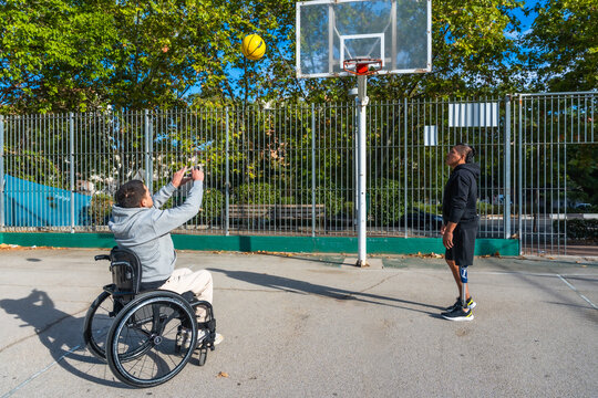 People with disabilities playing basketball on outdoor court