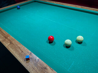 Colorful Cue Balls on a Billiard Table Ready to Play