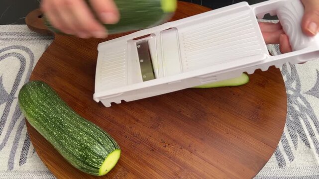 Using a Mandoline Slicer to Cut Zucchini Into Thin Even Slices