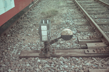 Close up of old railway switch lever and signal on track