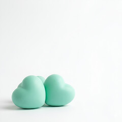Three slightly different mint-colored rubber hearts