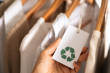Eco Tag with Recycle Symbol on Sustainable Clothing Hanger for Ethical Fashion Concept