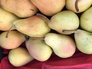 Fresh Yellow Pears in a Market Box. Autumn Harvest Fruit. Pyrus communis isolated.