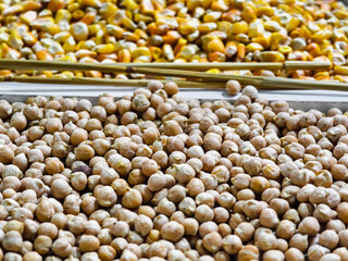Colorful display of peas and corn at a vibrant market stall
