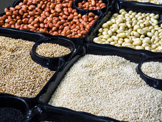 Colorful display of dried nuts and seeds in bins at a local market
