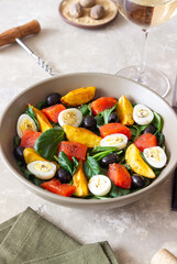 Salad with salmon, spinach, baked potatoes, olives and eggs. Healthy eating. Diet.