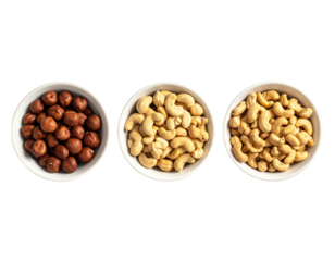 Three small white bowls filled with nuts. Hazelnuts, cashews, and more cashews are visible