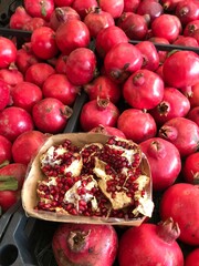 Fresh Pomegranates and Seeds Displayed at Market – Juicy Red Fruit. Punica granatum isolated. mediterranean fruits close up.