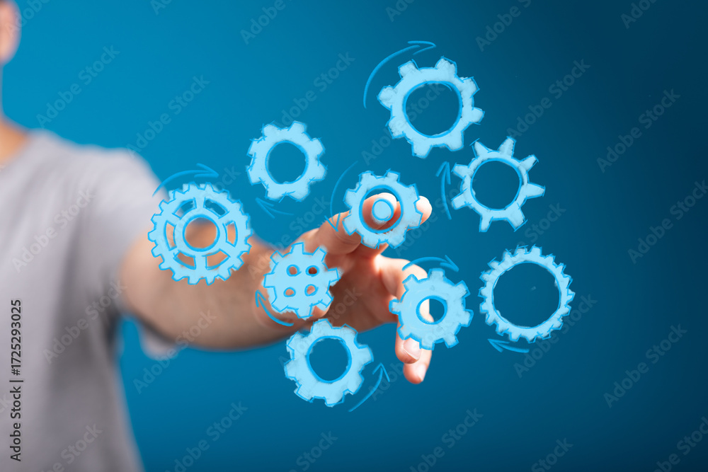 Poster abstract image of a hand interacting with gears, symbolizing teamwork, collaboration, and process op