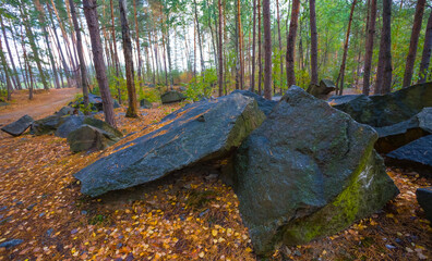 heap of huge stones among autumn forest