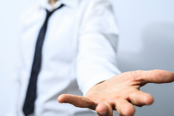 Obraz premium Image of a businessman's open hand, symbolizing help, support, and opportunity. Perfect for business, teamwork, and collaboration concepts