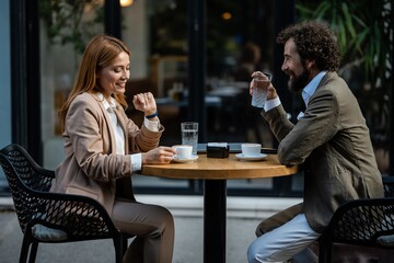 Business people having informal meeting at outdoor cafe