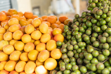 Tropical fruit market stall selling fresh jocote and mamoncillo