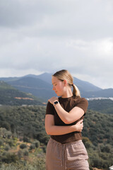 Naklejka premium Mindful mountain retreat: woman meditating outdoors, eyes closed; eco travel, breathwork, slow living, nature connection, inner calm, digital detox