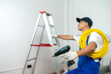 Electrician at Work: A skilled electrician, meticulously ascends a ladder, poised to install wiring. The image offers a clear, uncluttered view, emphasizing the precision and expertise