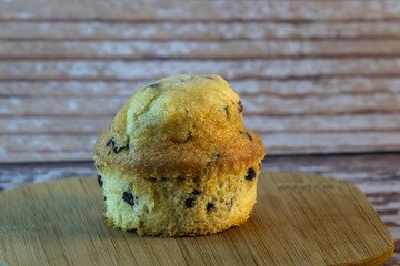 chocolate chip cookies, fresh chocolate chip muffin on wood