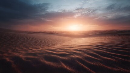 Dramatic desert sunset illuminating rippled sand dunes under a vibrant sky
