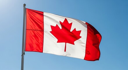 A national emblem billows proudly against a clear, vibrant sky, displaying the iconic Canadian flag.