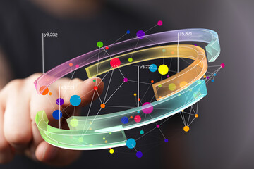 Abstract image of a hand interacting with a 3D data visualization. Colorful nodes and arcs represent data points and connections.