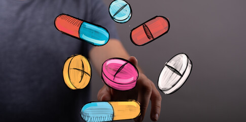 Abstract image of hand interacting with colorful pills and capsules.  Healthcare, medicine, pharmacy concept.