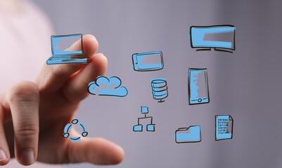 Hand interacting with digital icons: laptop, cloud, smartphone, data, network.  Modern technology concept.