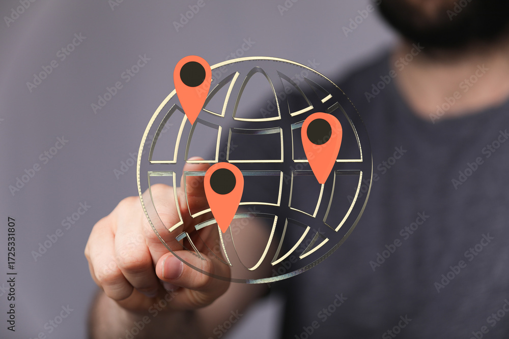Poster hand interacts with a digital globe showing multiple location markers. represents global reach, netw