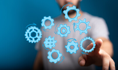Abstract image of a man interacting with digital gears. Perfect for concepts like teamwork, process, innovation, technology, and workflow.