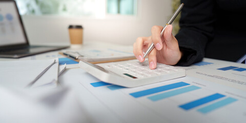 Data Evaluation. Professional analyzing financial reports with calculator and pen.