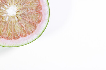 Halved Pomelo in the Corner of a White Background Photo