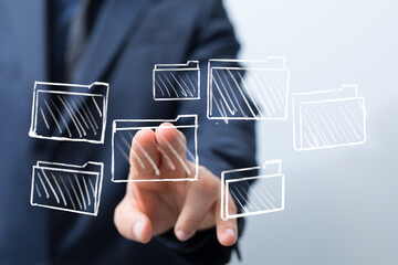 Hand selecting file folder icons,digital organization, data management, cloud storage concept.